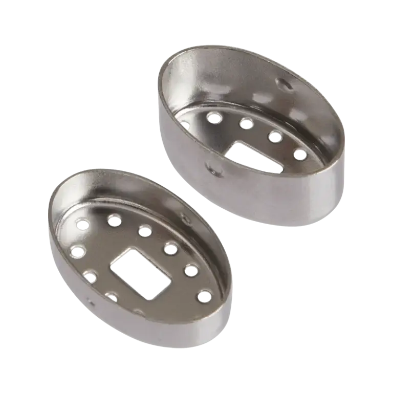 The stainless steel top and bottom of a DaVinci MIQRO dosing capsule shown disassembled, each oval-shaped piece featuring a central rectangular slot surrounded by a ring of circular airflow holes.
