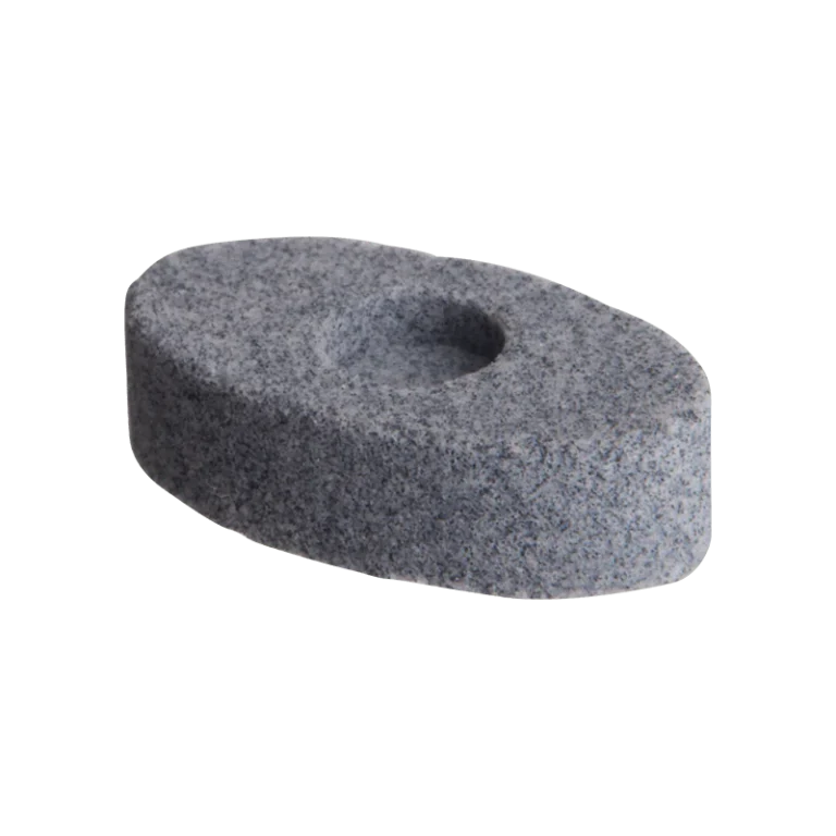 Close-up of a single DaVinci MIQRO grey porous ceramic extract pad, shown at an angle. The oval disc has a speckled granite-like texture with a small central indent for holding concentrates.