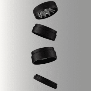 A matte black four-piece herb grinder shown as an exploded view with all sections separated and floating vertically against a grey gradient background. From top to bottom: the lid with grinding teeth visible inside, the upper grinding chamber, the lower collection chamber with a mesh screen, and the flat catch tray at the bottom.